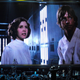 An orchestra on stage with Star Wars on a giant screen.